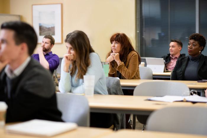 研究生 students sitting in classroom listening to instruction